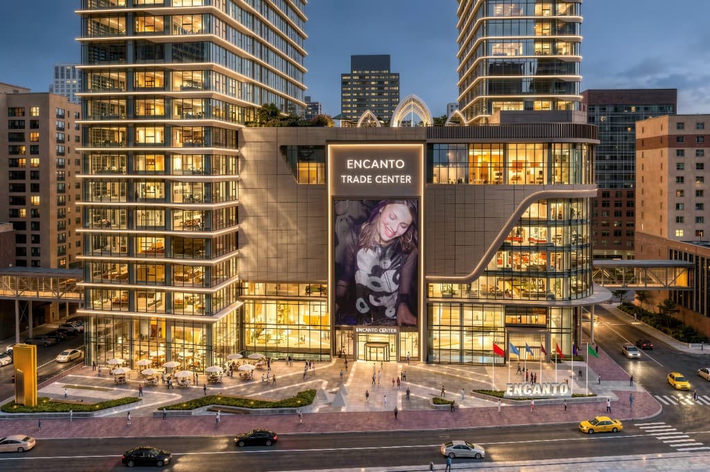 Encanto Trade Center exterior at dusk with illuminated retail podium and towers